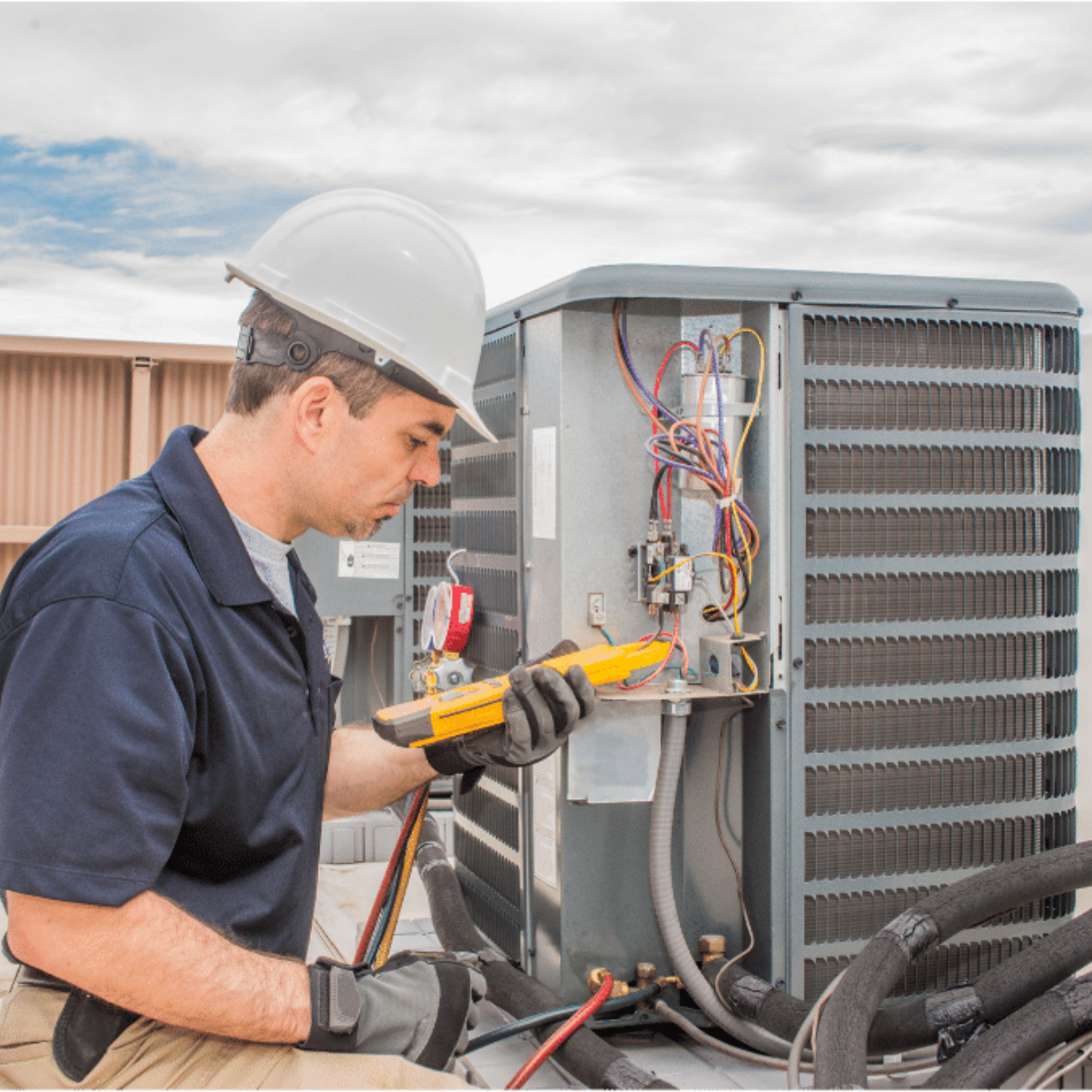 Whitby Heating & Cooling HVAC technician servicing a system