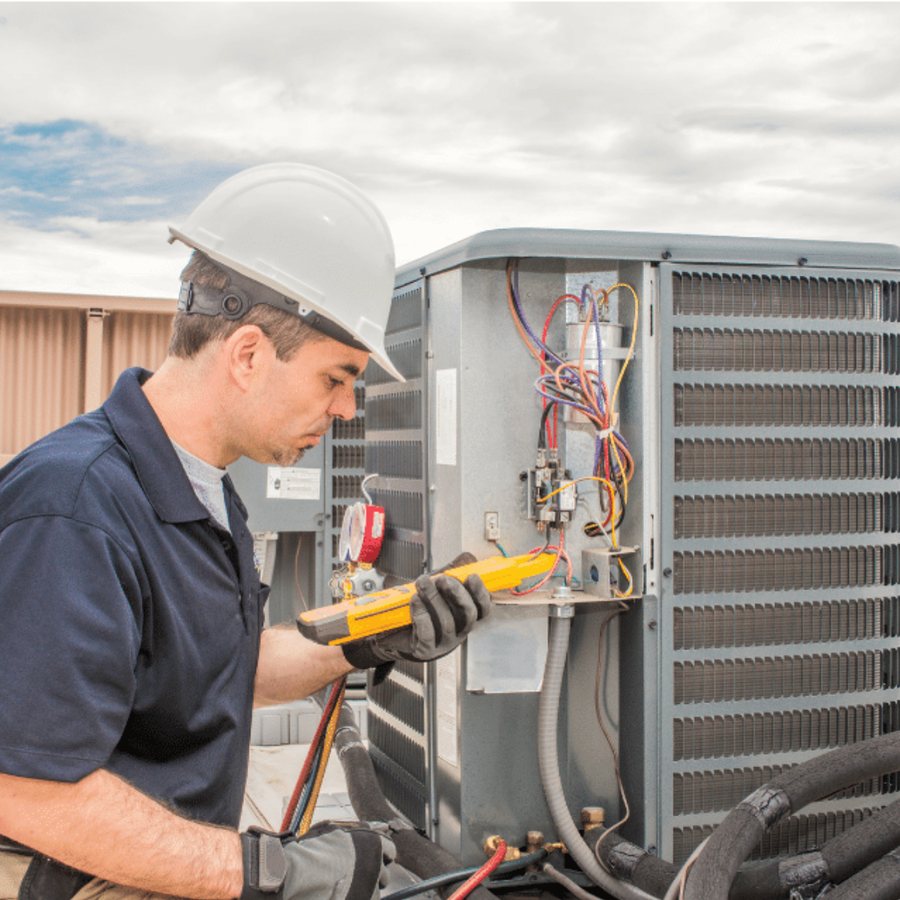 Whitby Heating & Cooling HVAC technician servicing a system